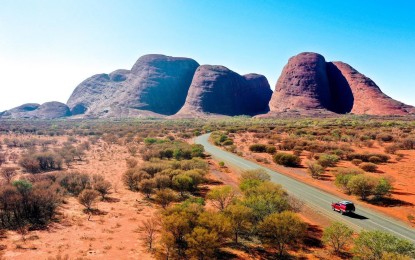 car driving on highway towards rocks